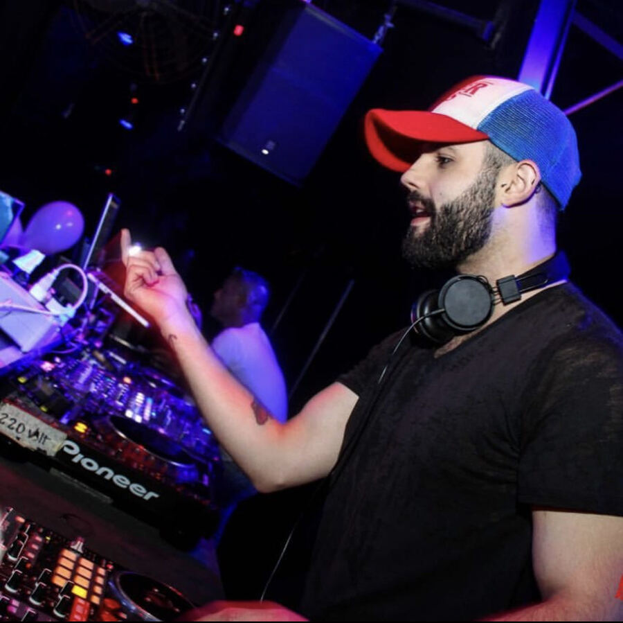 Mascari at a night club, headphones on